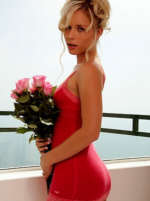 Glam babe Kara Duhe in her skimpy, pink dress on the terrace showing her pink panties