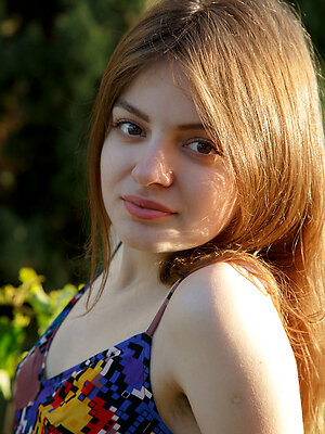 Klarissa shows off her bushy pussy as she poses outdoors.