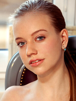 Kimberly Kace displays her slender body, long legs and pink pussy on the chair.