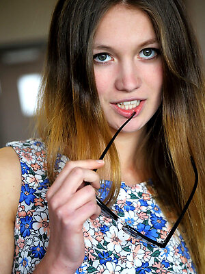 Wearing a blue floral tank top, cute pink panty, and sunglasses, Solveig portrays a fun and naughty teen who loves teasing in front of the camera.